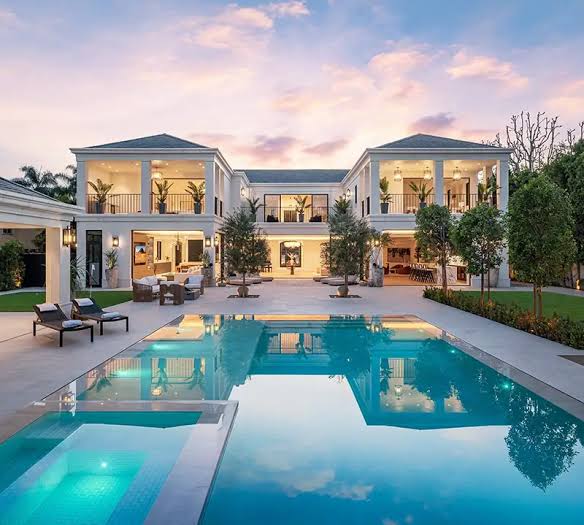 Luxury Aventura, Florida estate remodel with resort-style pool and open-air living spaces at sunset